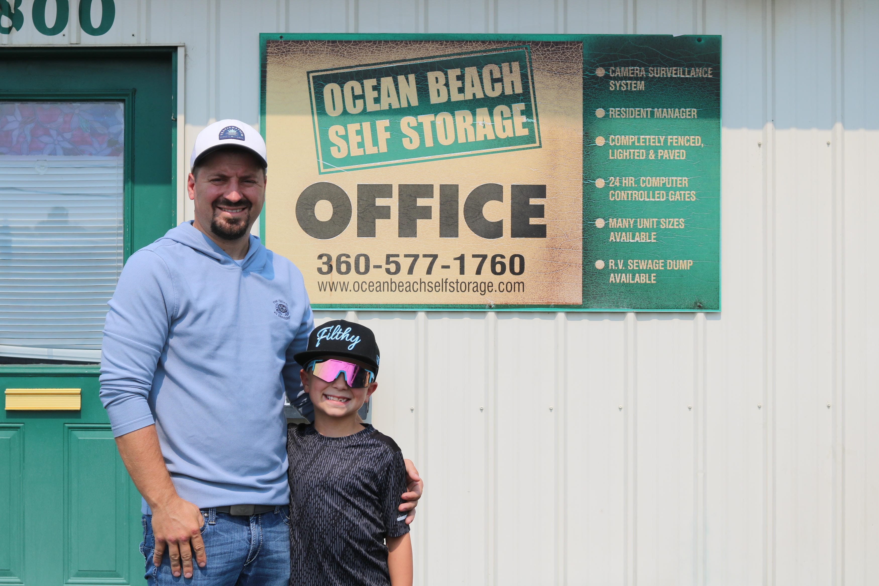 Clayton, on-site manager at Ocean Beach Self Storage, with his son at the office